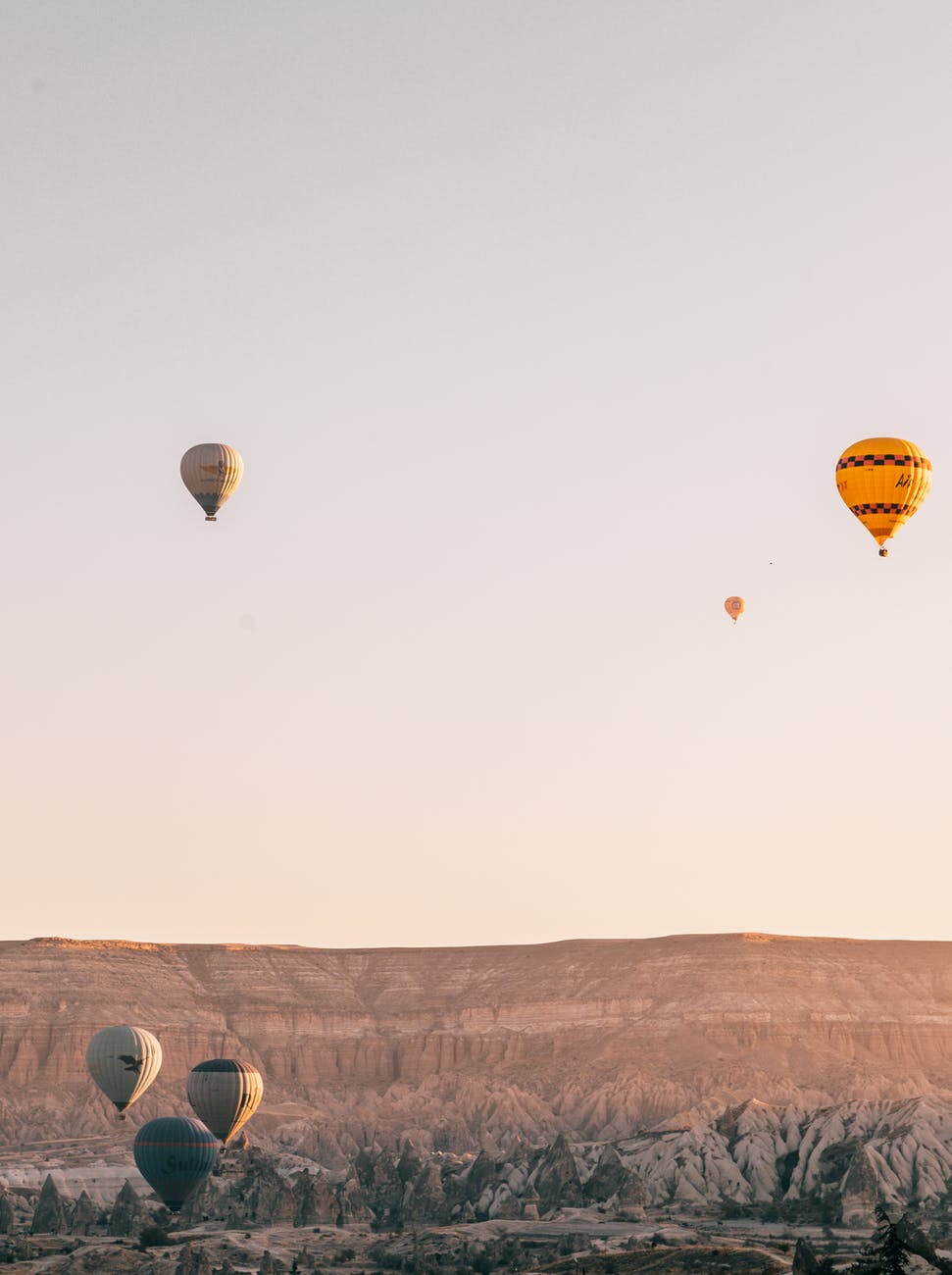 flying air balloons under mountain valley